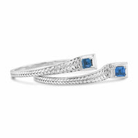 silver hoop earring with blue topaz