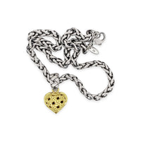 gold puffed heart pendant on silver necklace