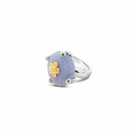 Silver ring with an agate stone and gold flower design on a white background