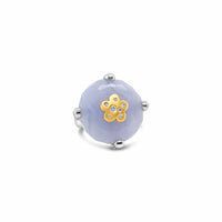 Jewelry ring with an agate stone and gold flower design on a white background
