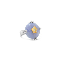 Ring with an agate stone and gold flower design with diamonds on a white background