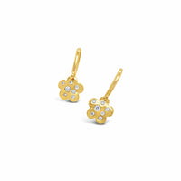 Gold flower-shaped earrings with embedded diamonds on a white background