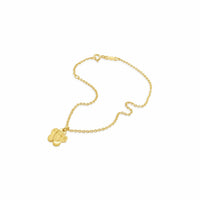 Gold bracelet with a flower shaped charm on a white background