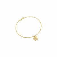 Gold bracelet with a flower-shaped charm on a white background