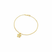 Gold bracelet with a flower pendant on a white background