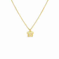 Gold necklace with a small flower pendant on a white background