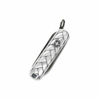 Silver pocket knife with intricate design on a white background